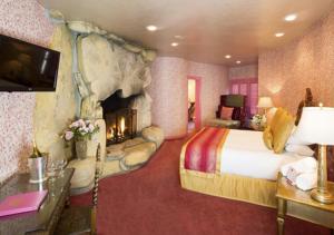 a hotel room with a bed and a fireplace at Madonna Inn in San Luis Obispo