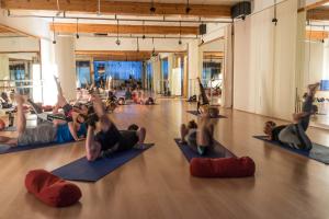 a group of people doing yoga in a gym at Aparthotel AnyosPark Mountain & Wellness Resort in Anyós