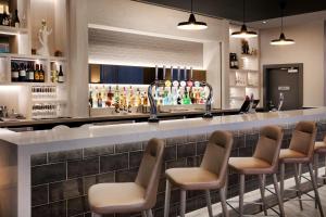 a bar with a row of chairs and a counter at Leonardo Hotel London Watford- Formerly Jurys Inn in Watford