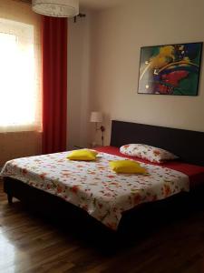 a bedroom with a bed with yellow pillows on it at Lorenz Apartment in Hattingen