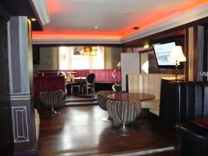 a restaurant with a table and chairs and a bar at Whites Hotel in Newcastle upon Tyne