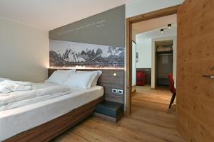 Posteľ alebo postele v izbe v ubytovaní Dolomeet Boutique Hotel