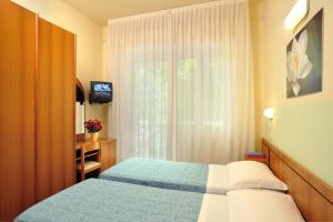 Postel nebo postele na pokoji v ubytování Hotel Capri