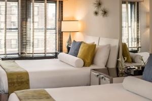 a living room with a white couch and a window at 70 Park Avenue Hotel in New York