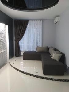 a living room with a bed and a window at Apartment on Tytova 8 in Dnipro