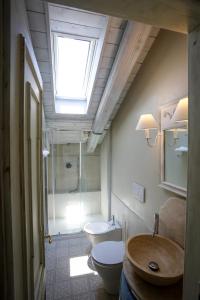 a bathroom with a sink and a toilet and a skylight at B&B Villa Ricardi in Moncalieri +26 photos