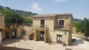 a large building with a staircase in front of it at Il Casale Delle Rose in Caltagirone