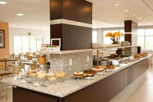a kitchen with a counter with food on it at Serras Hotel in Cuiabá
