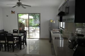 a kitchen with a table and chairs and a dining room at Casa Mango in Valladolid
