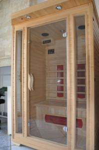 a sauna with glass doors in a room at Chambre d'hôtes Sauternais in Pujols-sur-Ciron