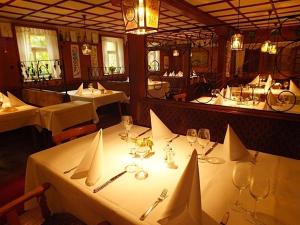 a dining room with white tables with wine glasses at Achkarrer Krone in Achkarren