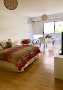 a bedroom with a bed and a dining room at Ocio Laprida in Buenos Aires