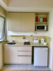 a small kitchen with a sink and a microwave at Ocio Laprida in Buenos Aires