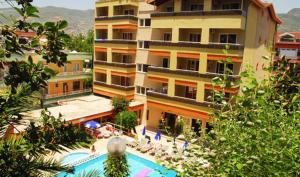 a building with a swimming pool in front of a building at Park Hotel in Alanya