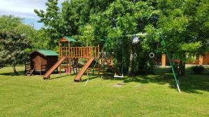 a playground in a park with a tree at La Chacra - Hotel de Campo & Spa in San Pedro