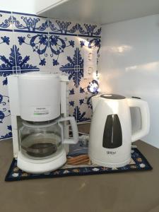 two white coffee makers sitting on a counter at Vivenda da bela vista in Costa da Caparica