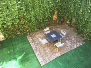 an overhead view of a table and chairs on a patio at Cocco House in Milan