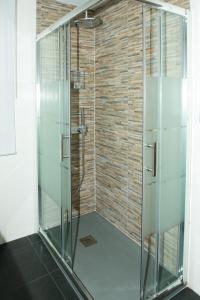 a glass shower in a bathroom with a brick wall at Parque del Carmen in Logroño +19 photos