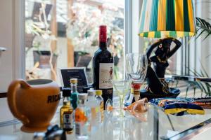 a table with a bottle of wine and glasses on it at BULC Boutique Bed & Breakfast in Belmont