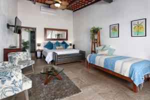 a living room with two beds and a couch at Hotel Vista Oceana Sayulita in Sayulita