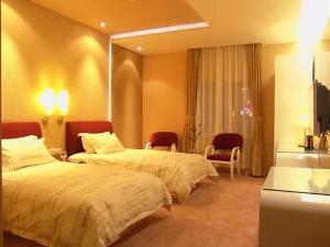 Krevet ili kreveti u jedinici u objektu Tomolo Hotel Wuzhan Branch