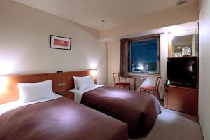 Giường trong phòng chung tại Candeo Hotels Ueno Park