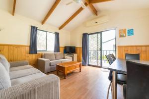 a living room with a couch and a table at Deniliquin Riverside Caravan Park in Deniliquin