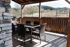 a patio with a table and chairs on a porch at Villa Maria, Complex Aleksandria in Dobrinishte