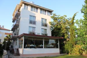 a large white building with glass windows at River Hotel in Manavgat