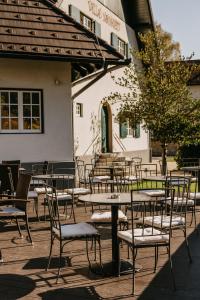 a group of tables and chairs in front of a building at Vila Monet in Laško