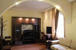 a living room with a couch and a tv at Shanhai-Blues in Odesa
