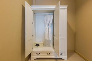 a closet with a white cabinet with a dresser at Zing Resort & Spa in Pattaya South