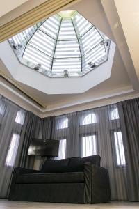a skylight in a bedroom with a black bed and windows at Superior One Boutique Hotel in Thessaloniki