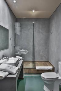 a bathroom with a sink and a shower and a toilet at Superior One Boutique Hotel in Thessaloniki