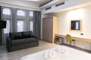 a living room with a bed and a couch at Superior One Boutique Hotel in Thessaloniki