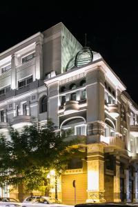 a large white building with a clock on top of it at Superior One Boutique Hotel in Thessaloniki