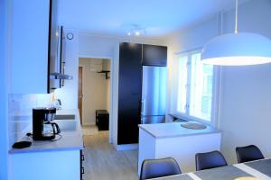 a kitchen with a table and chairs in a room at Apartment City-Pekka in Rovaniemi