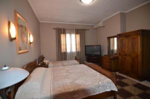 Voodi või voodid majutusasutuse Real Scampis Hotel toas