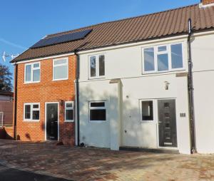 a white house with a garage at 3 Bed Farnborough Air Accommodation in Farnborough