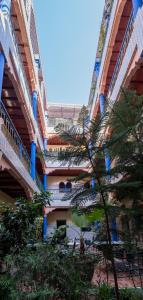 a large building with stairs and trees in front of it at Hotel Central Palace in Marrakech