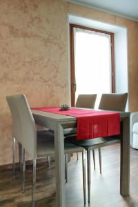 a dining room table with a red table cloth on it at La Maison de Pagan Alloggio ad uso turistico VDA CHARVENSOD n 0021 in Aosta