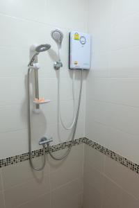 a shower in a bathroom with a shower head at Baan Por Pla Resort in Prachuap Khiri Khan