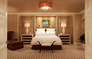 
a hotel room with a large bed and a large mirror at Encore at Wynn Las Vegas in Las Vegas
