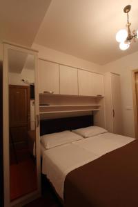 a bedroom with a bed with a large white bedvisor at Villa Violić in Zaton