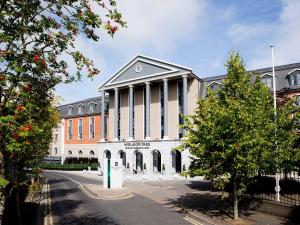 a large building with columns on the front of it at Midlands Park Hotel in Portlaoise