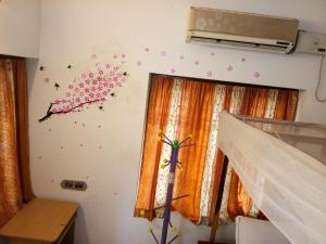a room with a wall with a cherry blossom wall sticker at Gone Coastal Homestay in Varkala