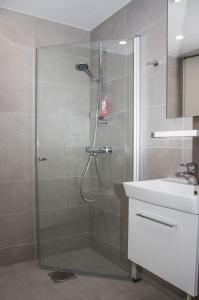 a bathroom with a shower and a sink at Lahti City Home in Lahti +39 photos