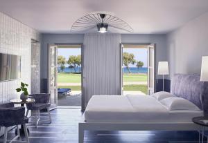 A bed or beds in a room at Kalimera Kriti Hotel & Village Resort