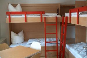 a room with two bunk beds and a desk at ZirkelsteinResort gGmbH in Schöna