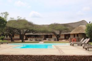 a resort with a swimming pool and a building at Bayala Private Safari Lodges in Hluhluwe